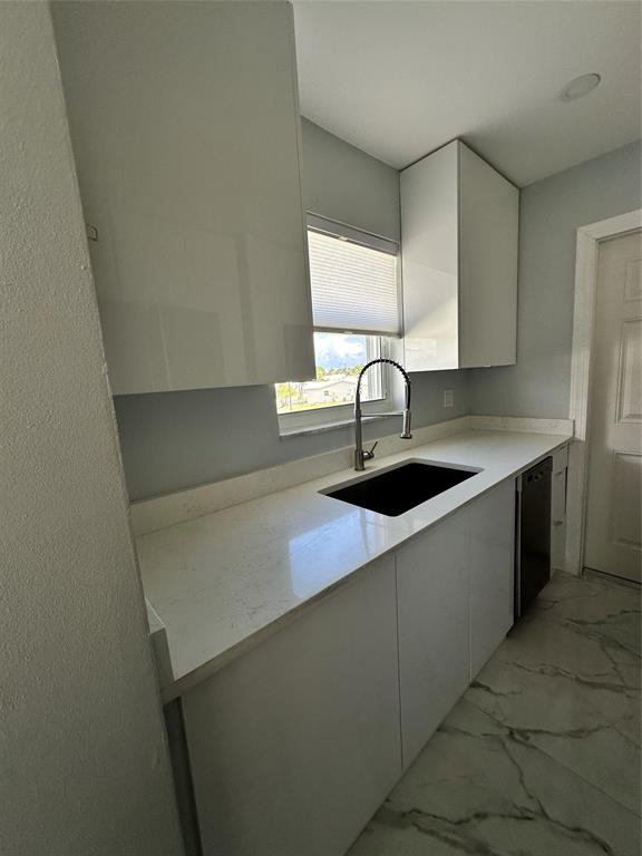 2701 East Golf Boulevard, Unit 2017 Pompano Beach, FL 33064 - Photo 8 of 26 a kitchen with a sink and a refrigerator