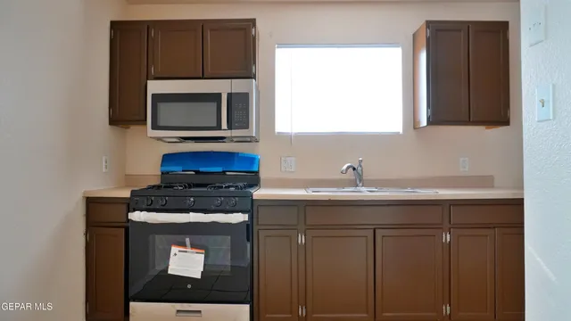 a view of a kitchen with sink and washing machine