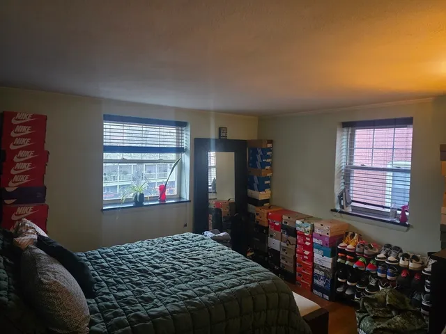 a bedroom with a bed and a window