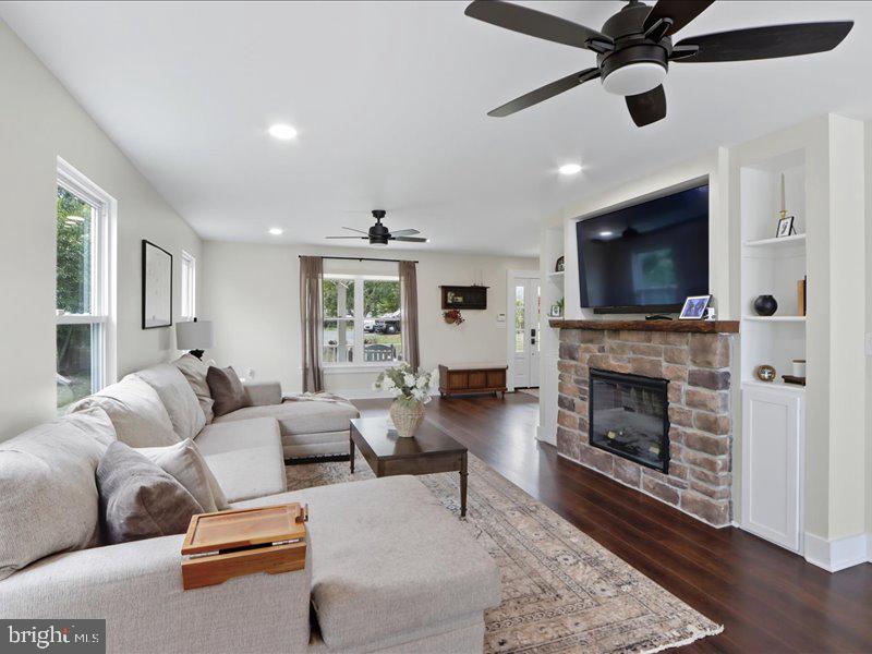 706 East Shore Road Pasadena, MD 21122 - Photo 15 of 32 a living room with furniture a fireplace and a flat screen tv