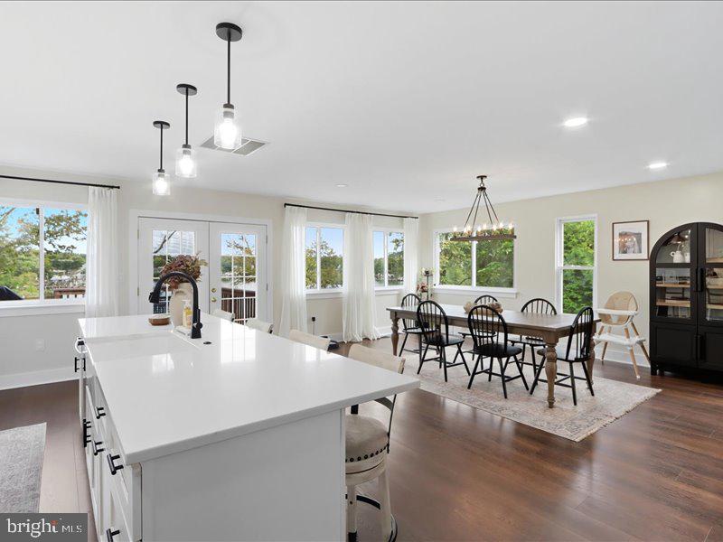 706 East Shore Road Pasadena, MD 21122 - Photo 17 of 32 a view of a dining room and livingroom with furniture window and wooden floor