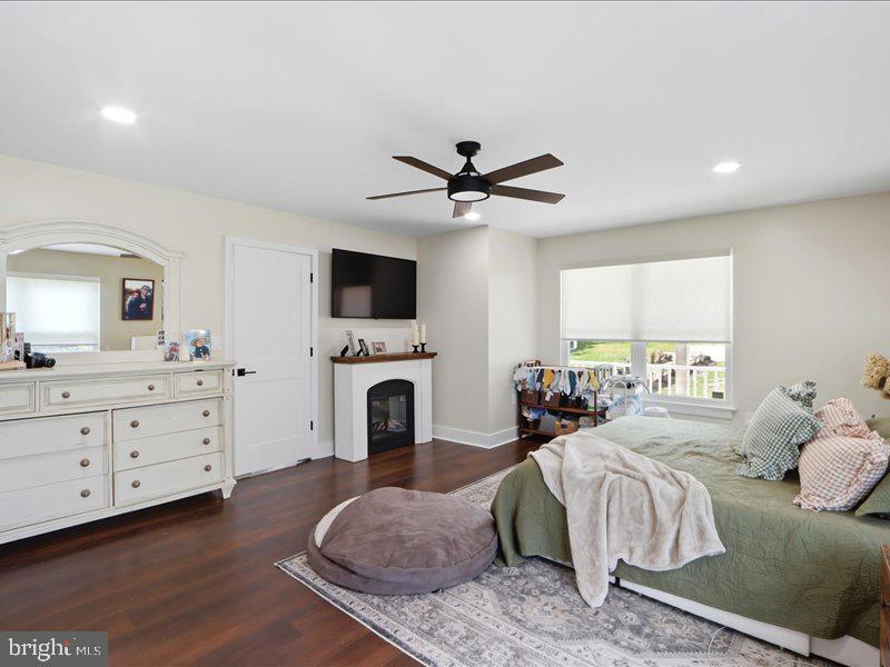 706 East Shore Road Pasadena, MD 21122 - Photo 22 of 32 a spacious bedroom with a large bed and a fireplace