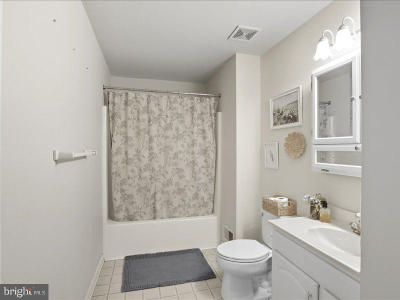 706 East Shore Road Pasadena, MD 21122 - Photo 27 of 32 a bathroom with a toilet a sink and a mirror