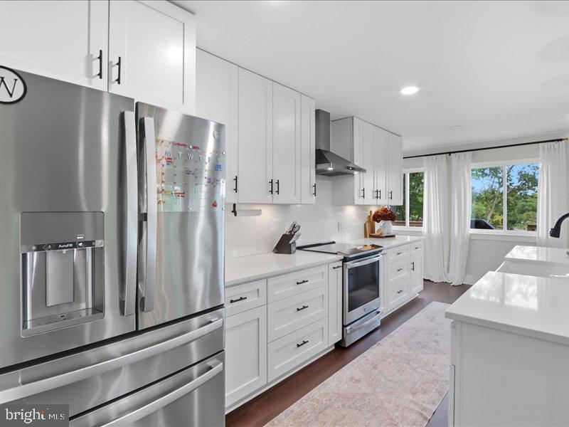 706 East Shore Road Pasadena, MD 21122 - Photo 6 of 32 a kitchen with stainless steel appliances a refrigerator sink and cabinets