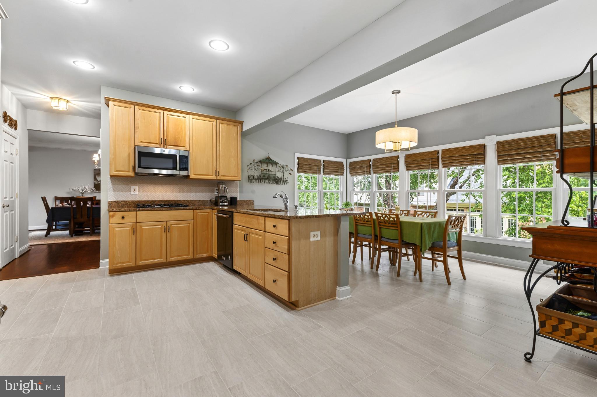 15006 Ransom Oaks Court Gainesville, VA 20155 - Photo 11 of 57 Bright and airy kitchen with dining area.