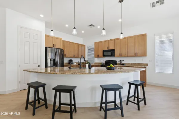 a view of kitchen with dining area refrigerator and window