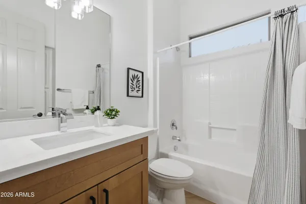 a bathroom with a sink a shower and a mirror