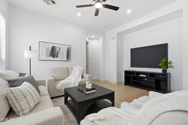 an empty room with wooden floor and a bathroom
