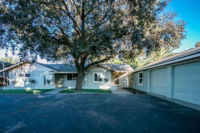 1218 Mitchell Road Modesto, CA 95351 - Photo 4 of 4 a view of a yard in front of a house with large trees