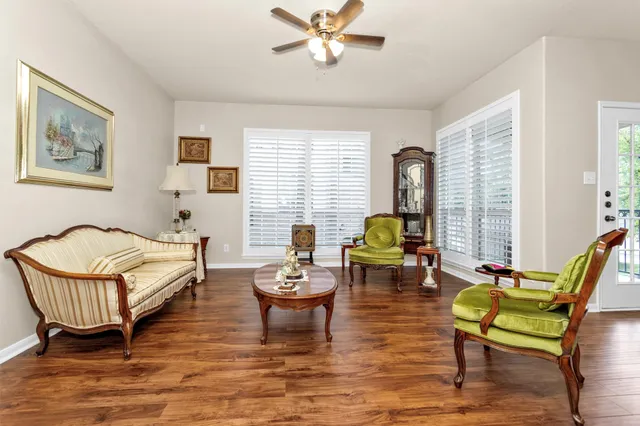 a living room with furniture a chandelier and a window