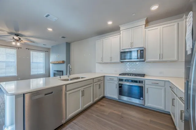a kitchen with stainless steel appliances granite countertop a sink and cabinets