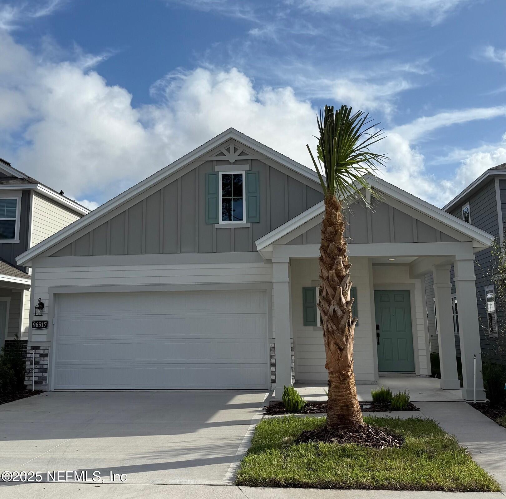 96517 Stillpoint Way Fernandina Beach, FL 32034 - Photo 1 of 9 a front view of a house with garden