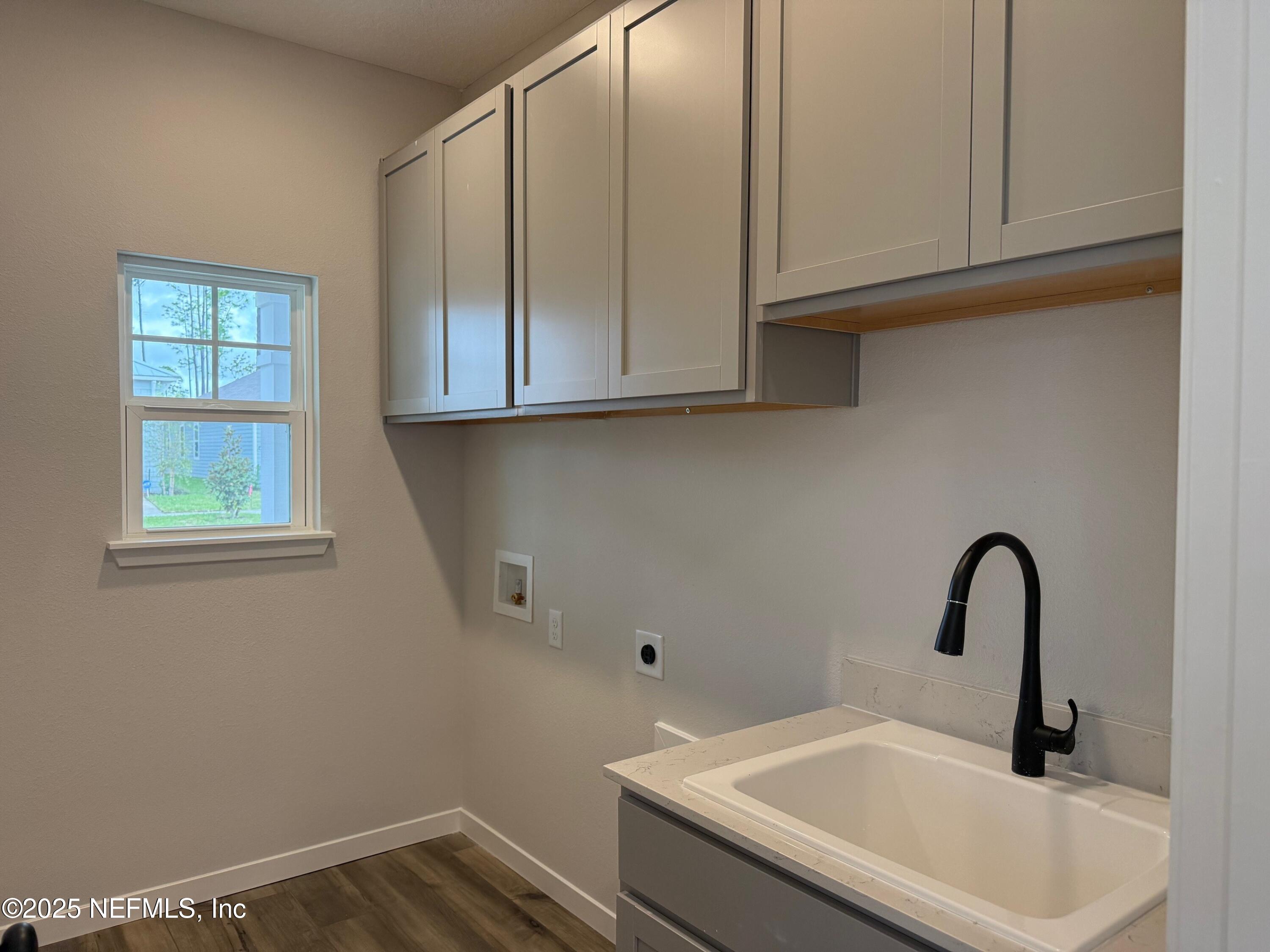 96517 Stillpoint Way Fernandina Beach, FL 32034 - Photo 2 of 9 a bathroom with a sink and cabinets