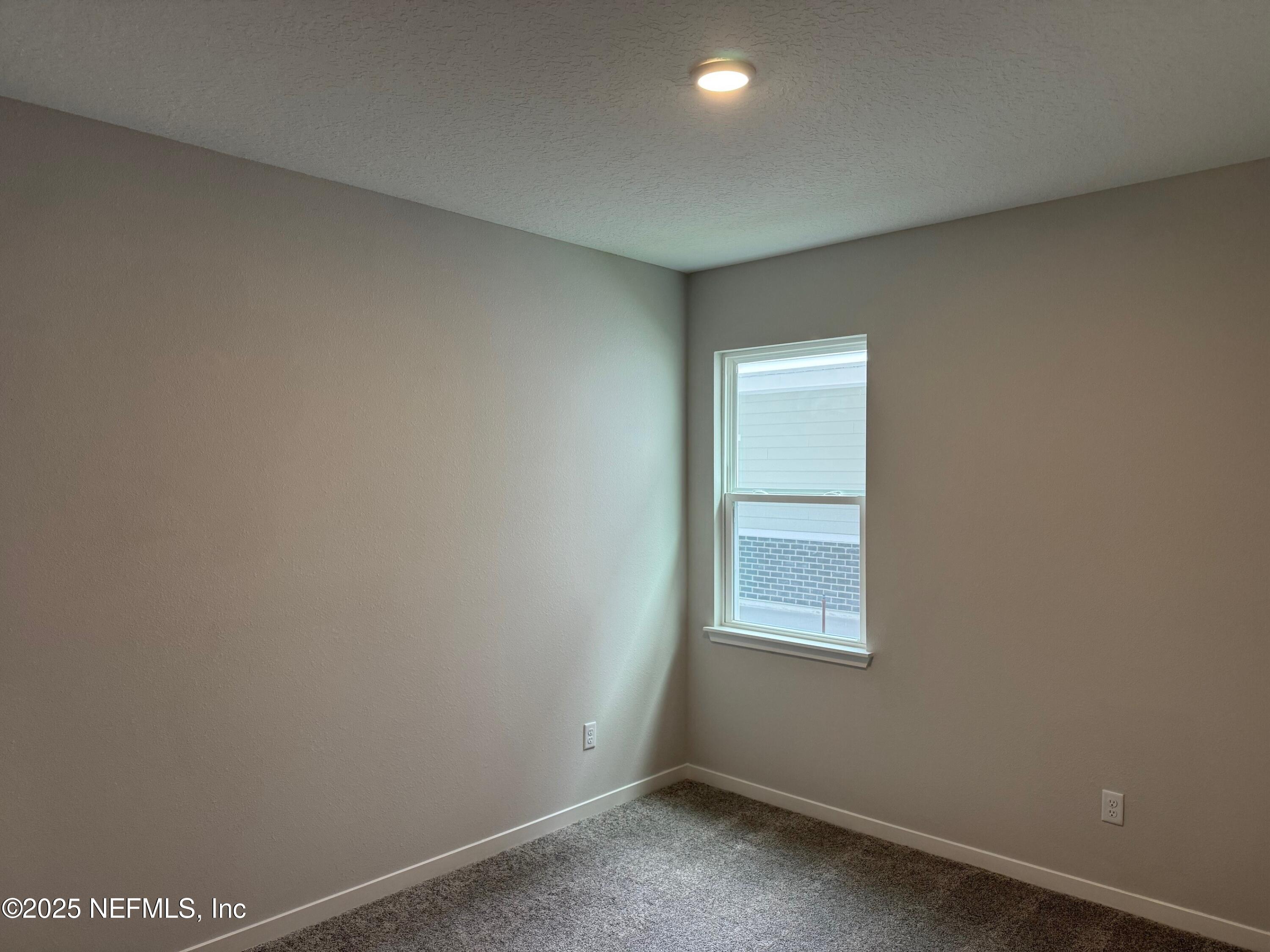 96517 Stillpoint Way Fernandina Beach, FL 32034 - Photo 4 of 9 a view of an empty room with a window