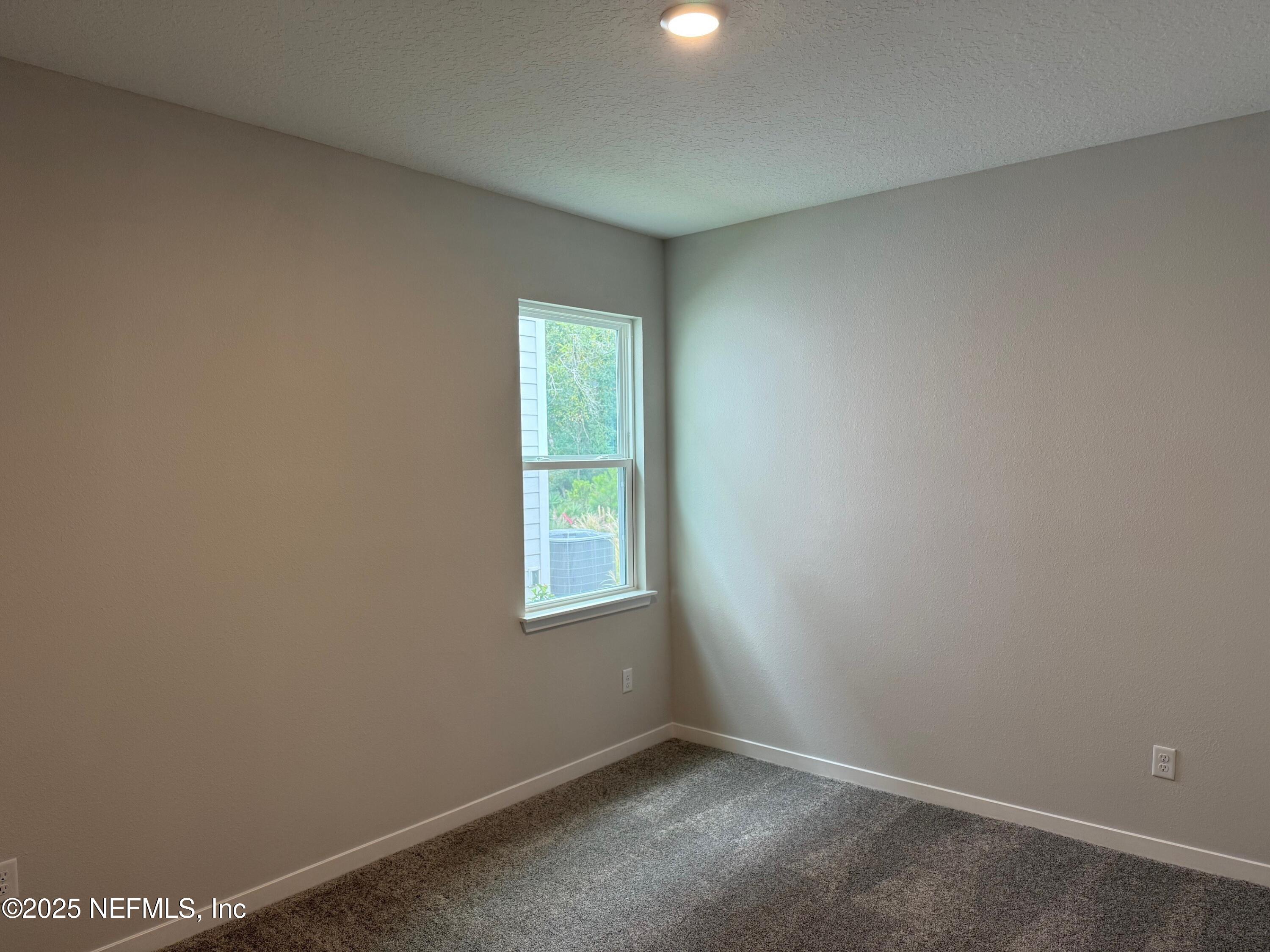 96517 Stillpoint Way Fernandina Beach, FL 32034 - Photo 5 of 9 an empty room with a window