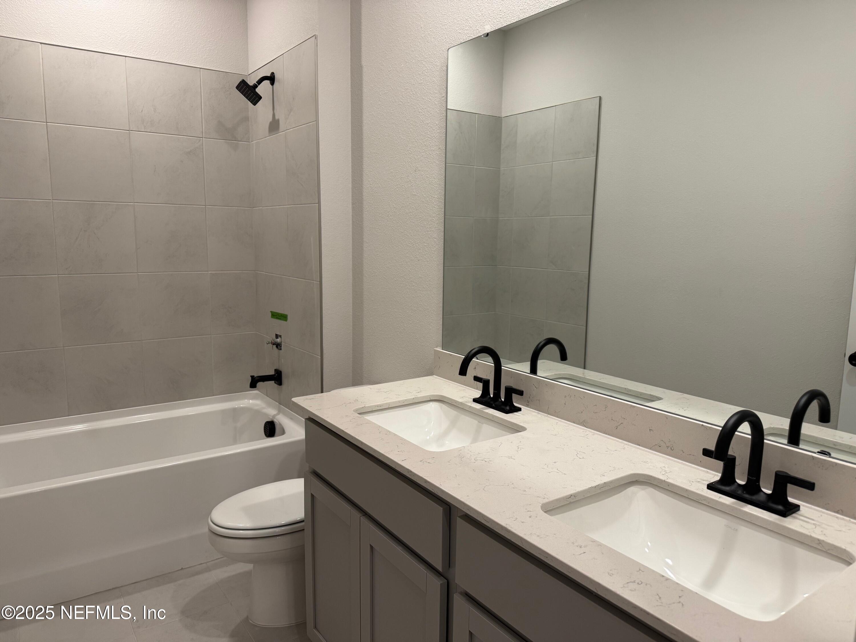 96517 Stillpoint Way Fernandina Beach, FL 32034 - Photo 7 of 9 a bathroom with a granite countertop sink toilet and shower