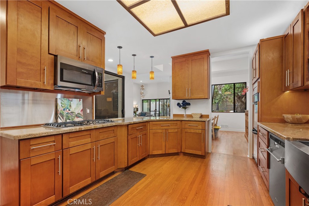 341 S Meadows Manhattan Beach, CA 90266 - Photo 19 of 54 a kitchen with stainless steel appliances granite countertop wooden cabinets a sink dishwasher a stove and a refrigerator