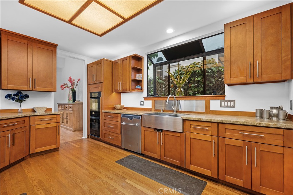 341 S Meadows Manhattan Beach, CA 90266 - Photo 21 of 54 a kitchen with stainless steel appliances kitchen island granite countertop a sink cabinets and wooden floor