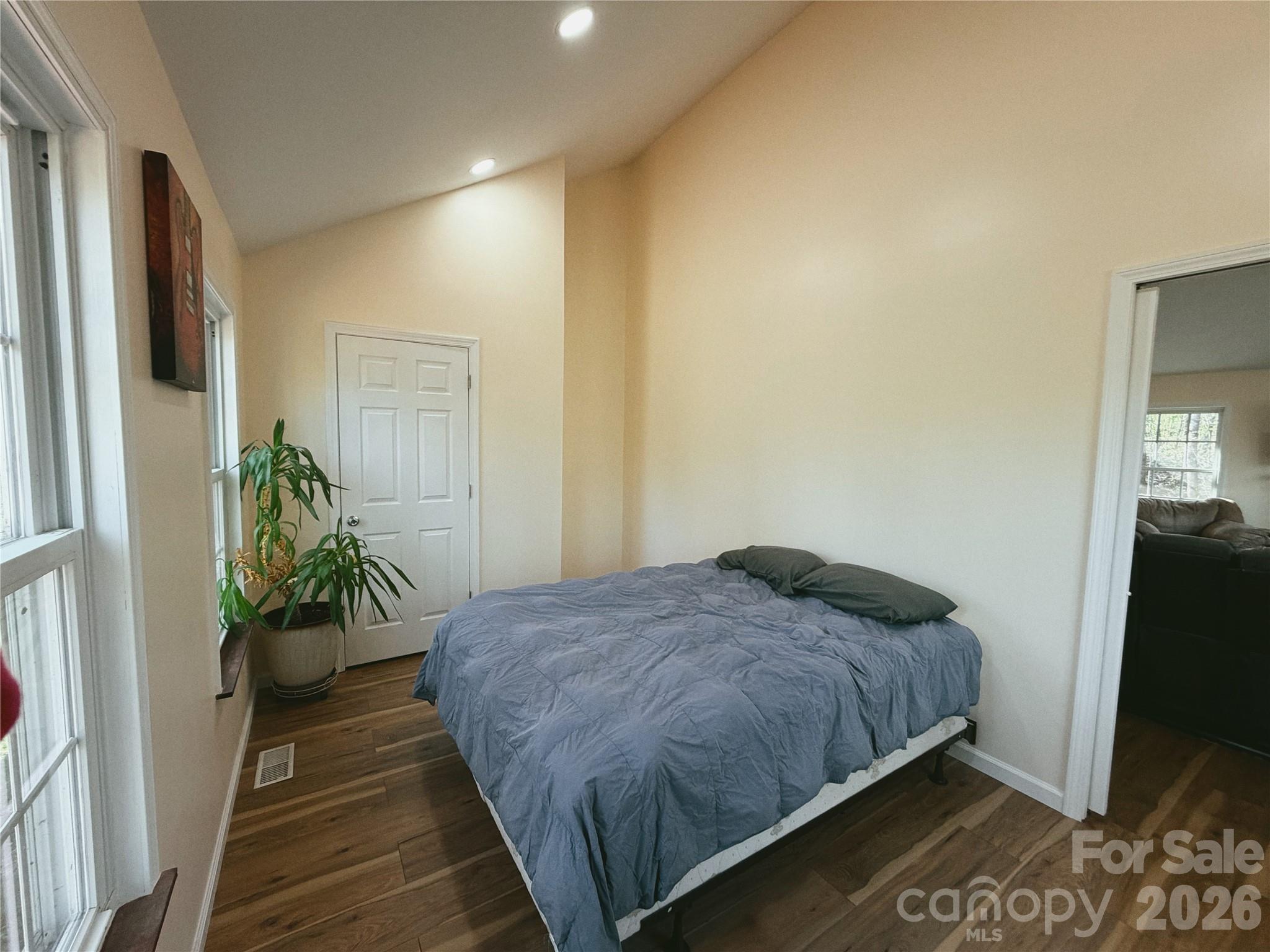6051 Pointe W Lane Vale, NC 28168 - Photo 15 of 28 a bedroom with a bed table and a potted plant