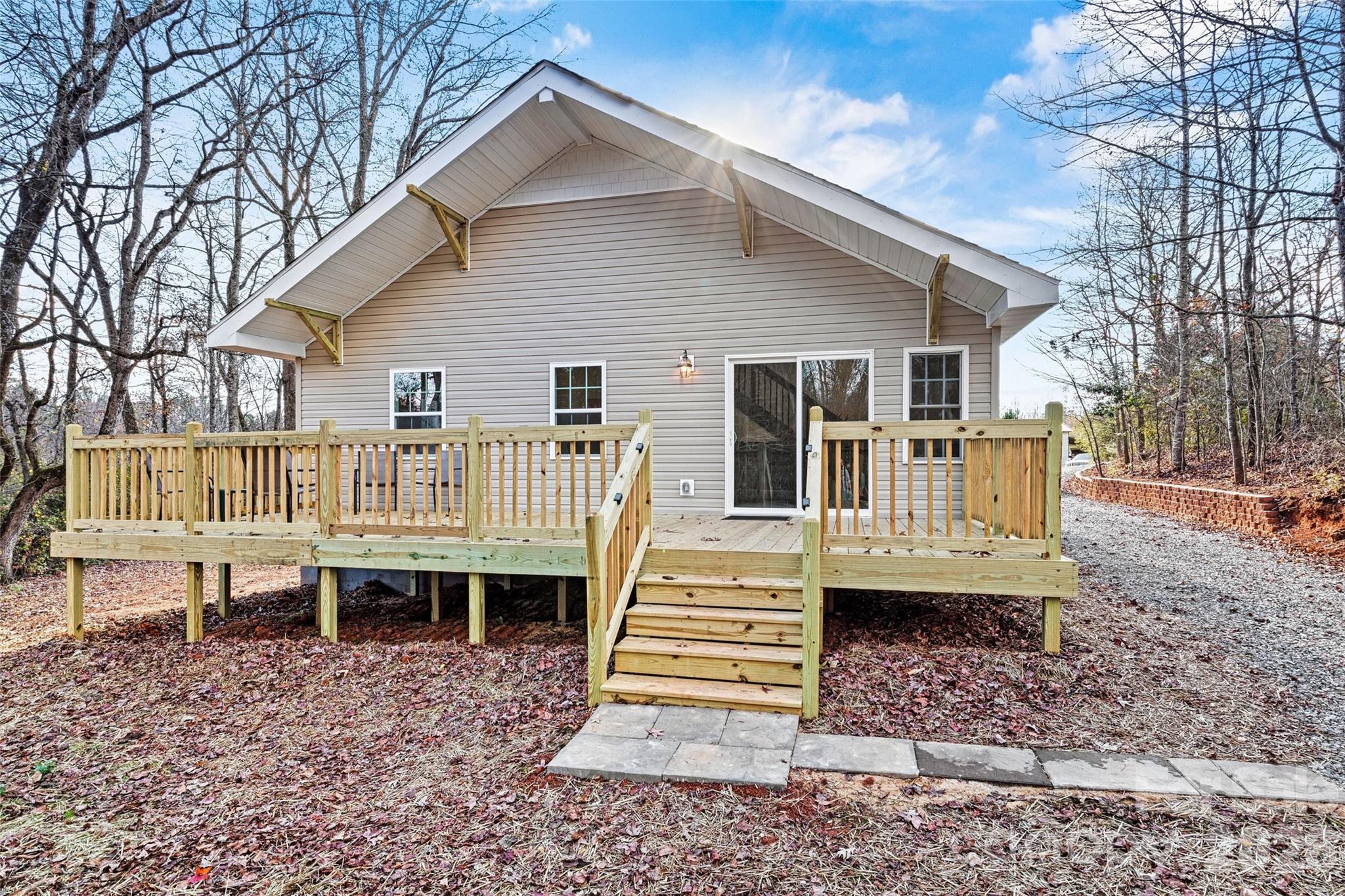 6051 Pointe W Lane Vale, NC 28168 - Photo 22 of 28 a view of a house with a yard and wooden deck