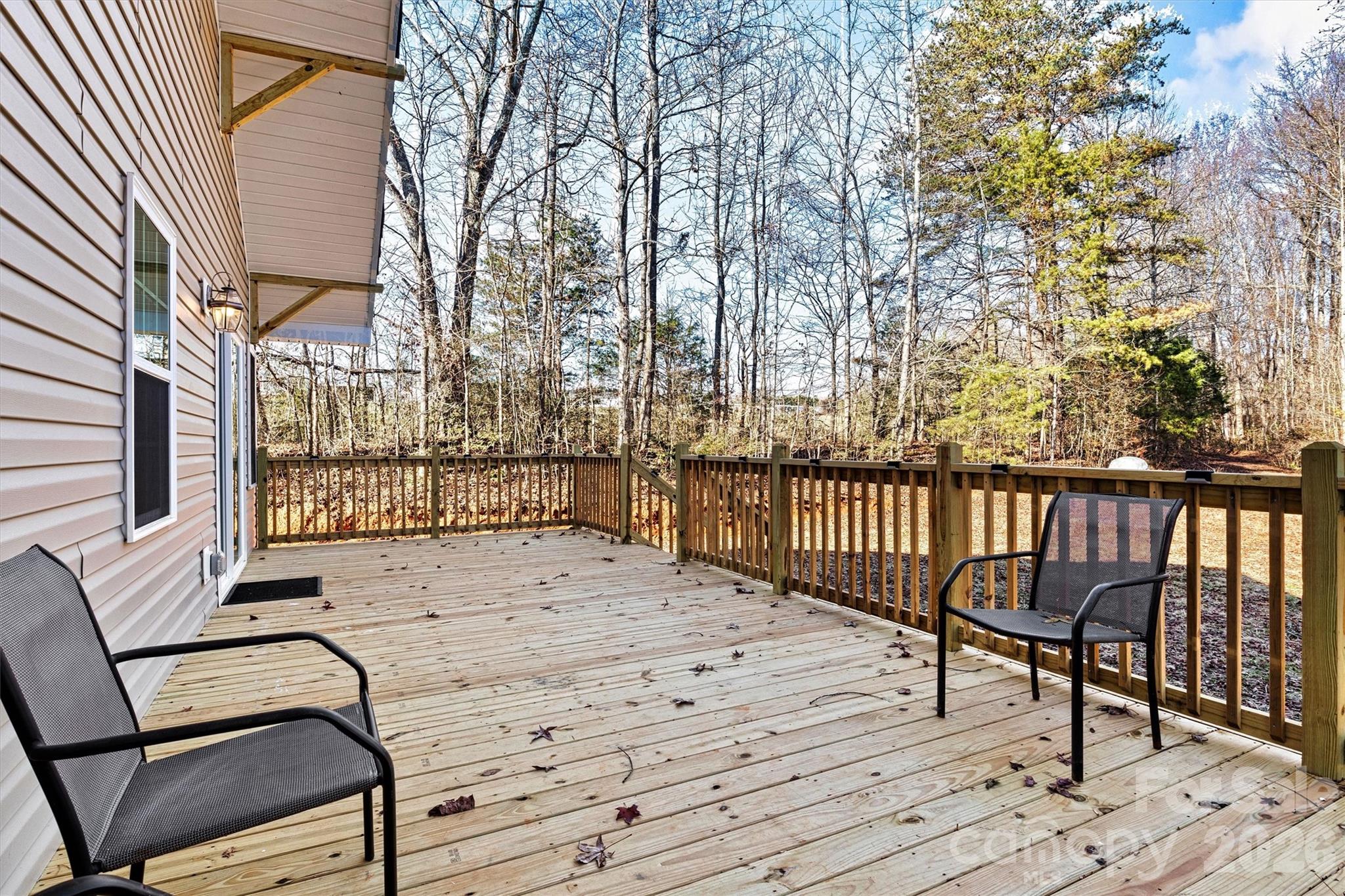 6051 Pointe W Lane Vale, NC 28168 - Photo 24 of 28 a view of a deck with chairs and wooden fence