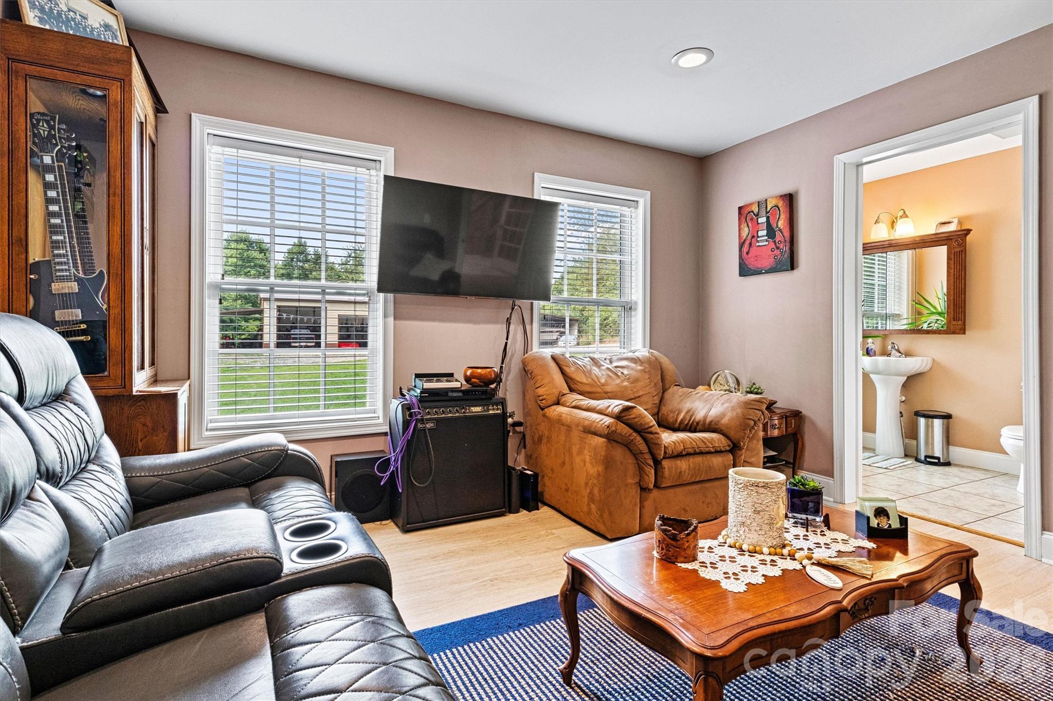 6051 Pointe W Lane Vale, NC 28168 - Photo 8 of 28 a living room with furniture a flat screen tv and a window