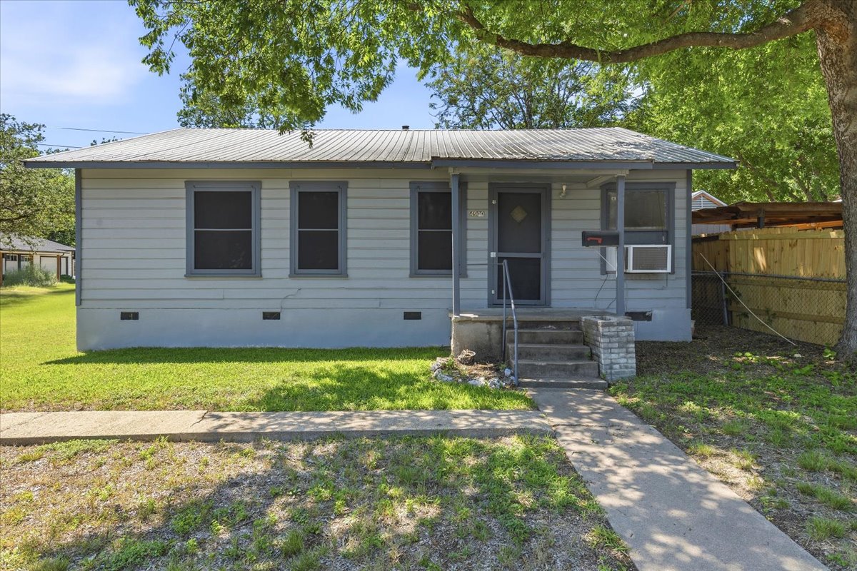 4900 Duval Street Austin, TX 78751 - Photo 2 of 25 Front view of the existing home on a Central Austin corner lot, shaded by mature trees and positioned with street frontage along Duval Street. The property offers vintage character, a simple original footprint, and strong potential for renovation, reconfiguration, or future redevelopment.