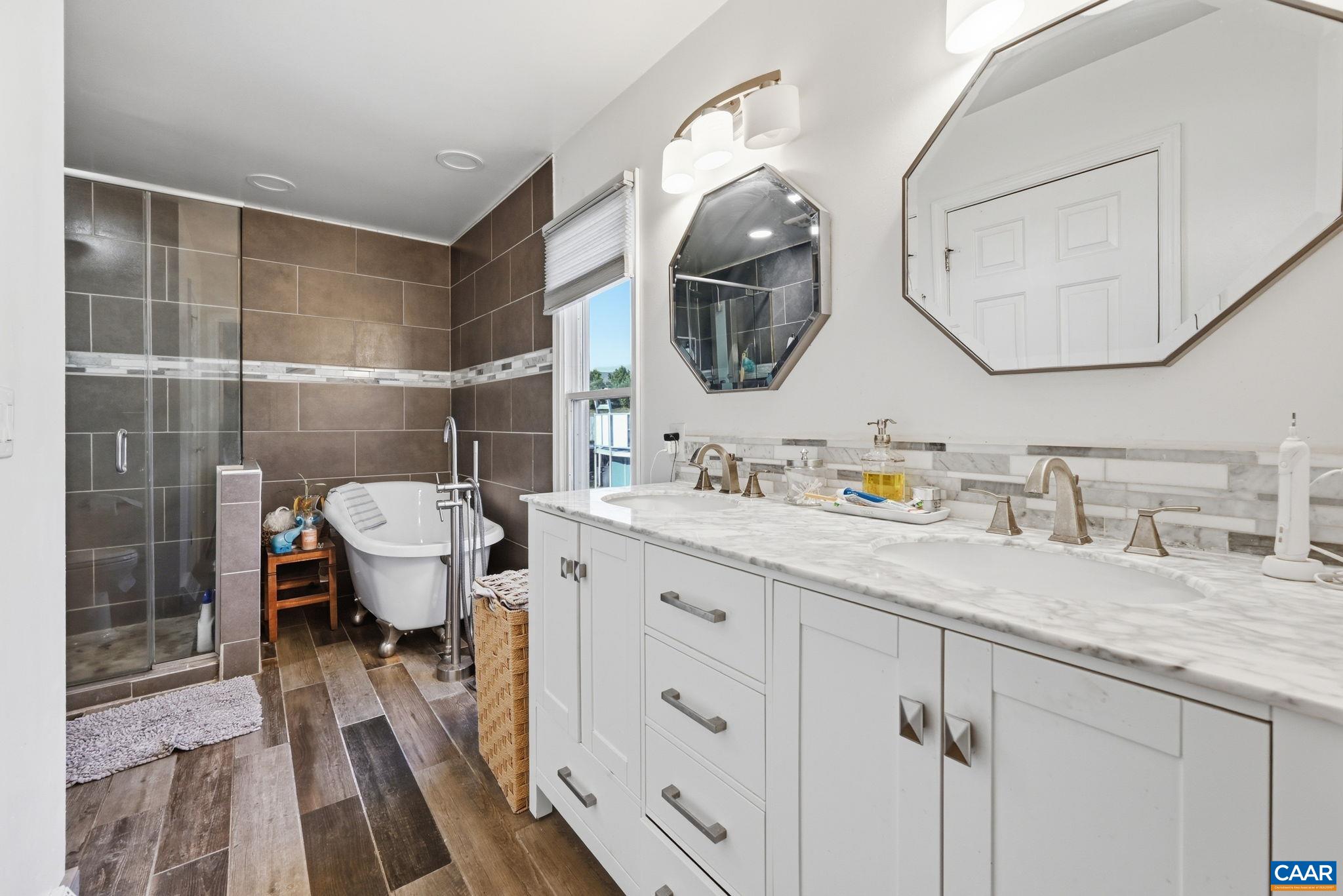 101 Marjorie Lane Ruckersville, VA 22968 - Photo 29 of 61 a spacious bathroom with a granite countertop sink mirror and vanity