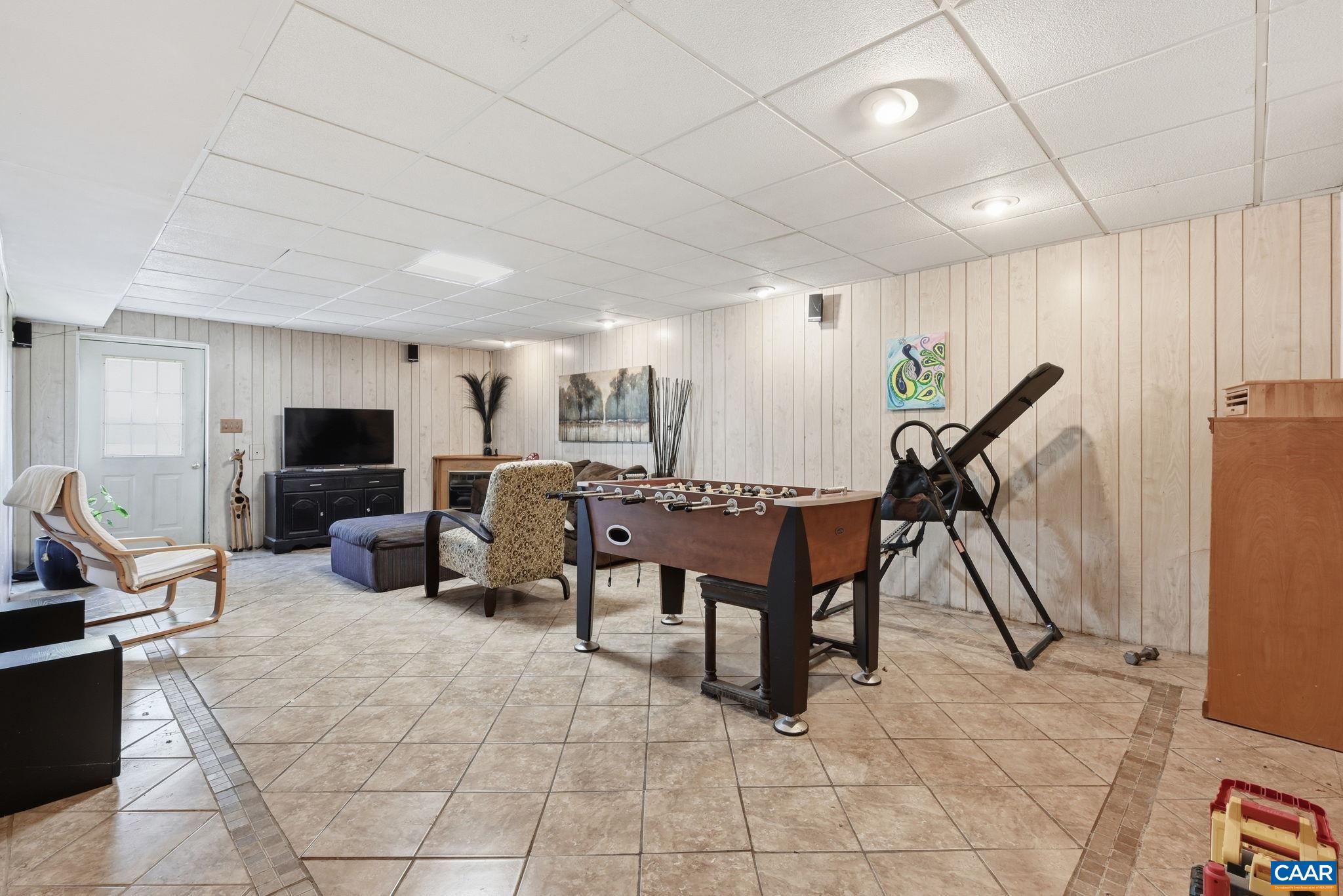 101 Marjorie Lane Ruckersville, VA 22968 - Photo 41 of 61 a living room with furniture a flat screen tv and a table