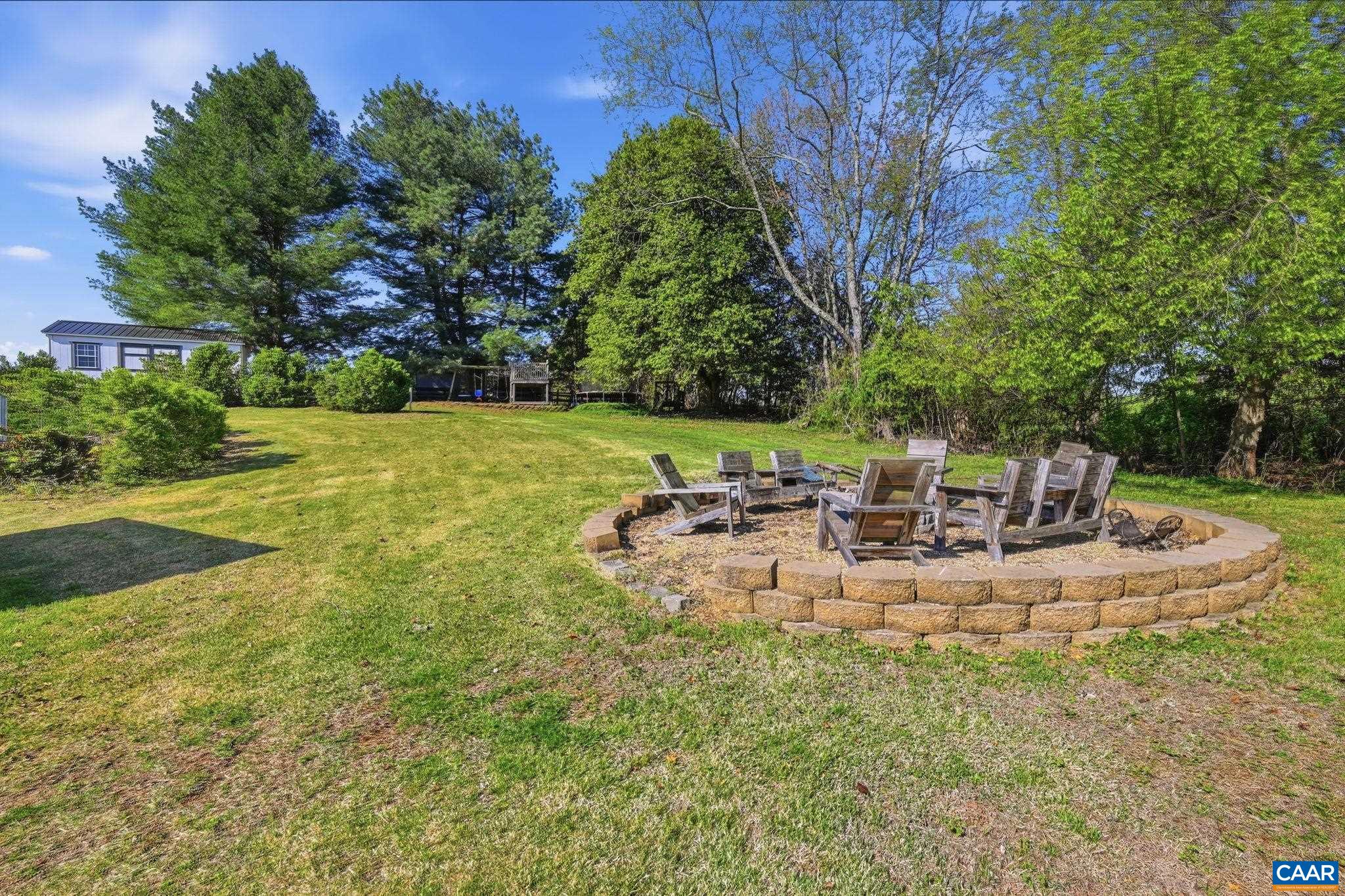 101 Marjorie Lane Ruckersville, VA 22968 - Photo 53 of 61 a view of a backyard with table and chairs under an umbrella