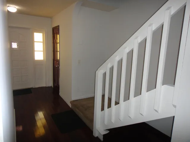 a view of a house with a backyard and balcony