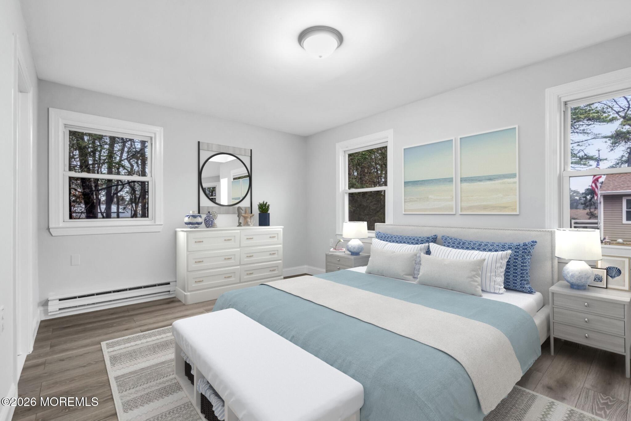 29 Keene Street, Unit 70 Whiting, NJ 08759 - Photo 14 of 18 a bedroom with a bed a mirror and a window