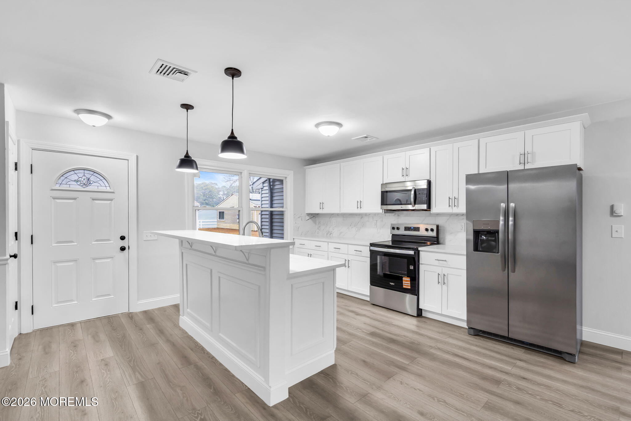 29 Keene Street, Unit 70 Whiting, NJ 08759 - Photo 3 of 18 a kitchen with stainless steel appliances granite countertop a refrigerator a oven a sink and white cabinets with wooden floor