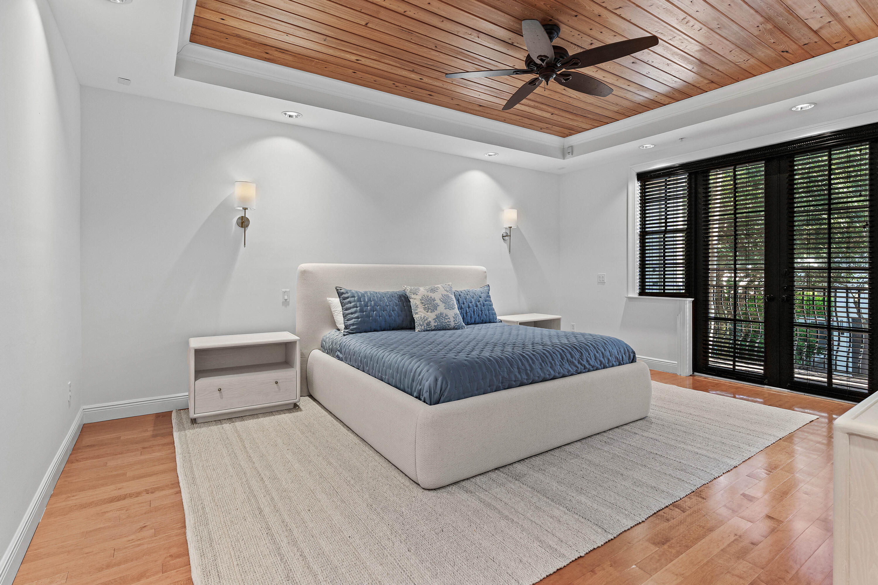 110 Gleason Street, Unit 203 Delray Beach, FL 33483 - Photo 13 of 25 a bedroom with a large bed and a ceiling fan