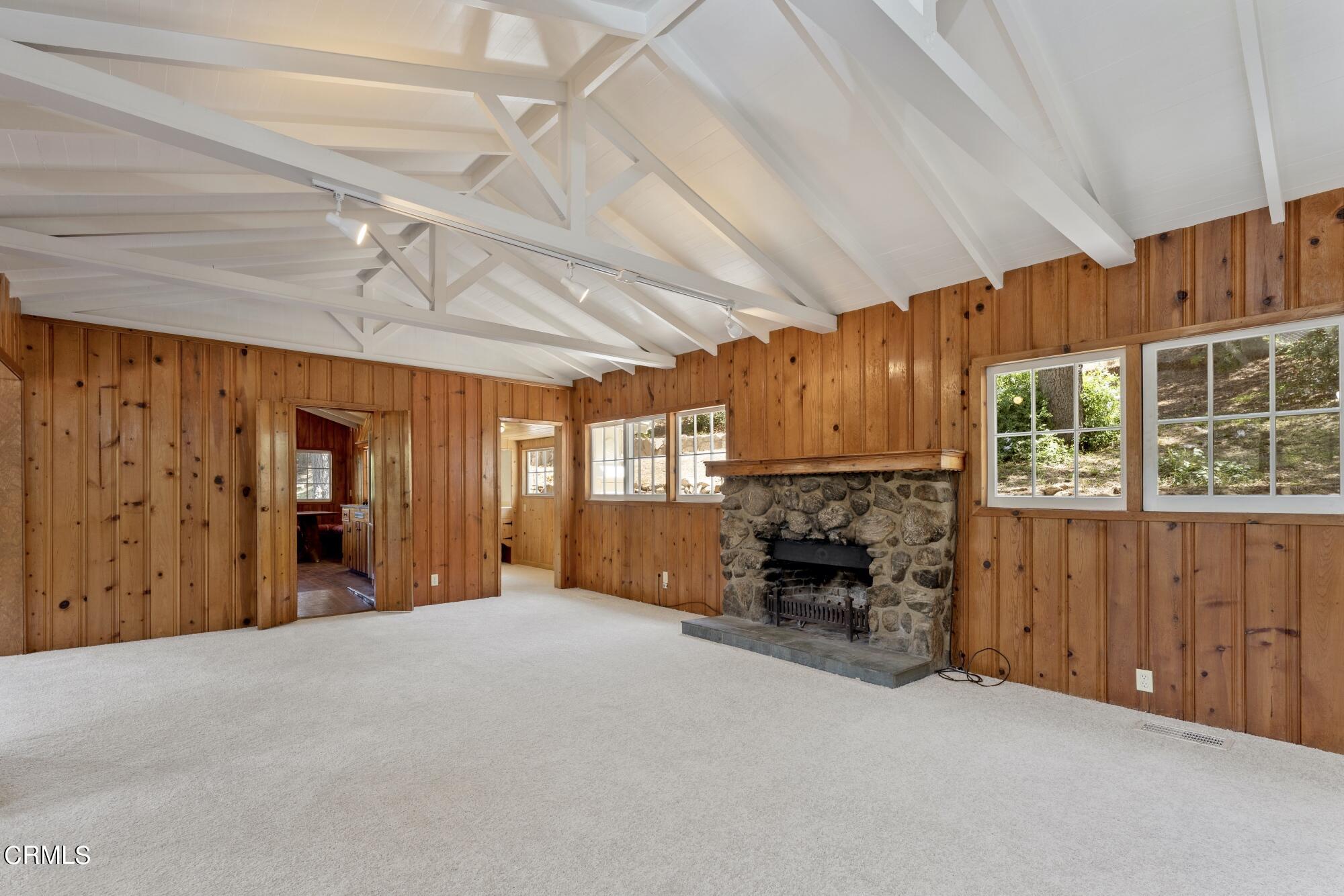 9710 Mistletoe Road Tujunga, CA 91042 - Photo 11 of 68 an empty room with fireplace fan and windows