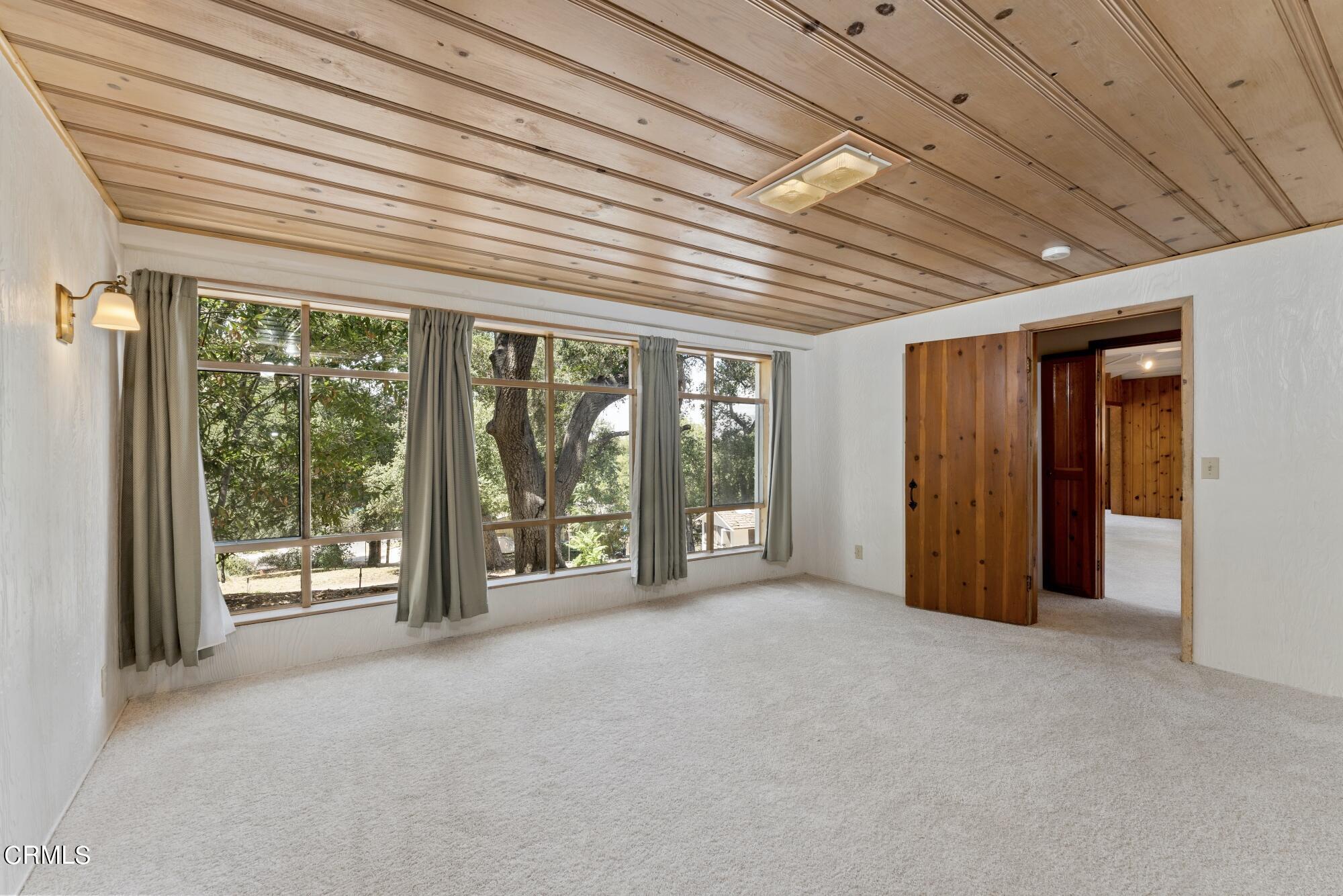 9710 Mistletoe Road Tujunga, CA 91042 - Photo 23 of 68 a view of an empty room with large windows