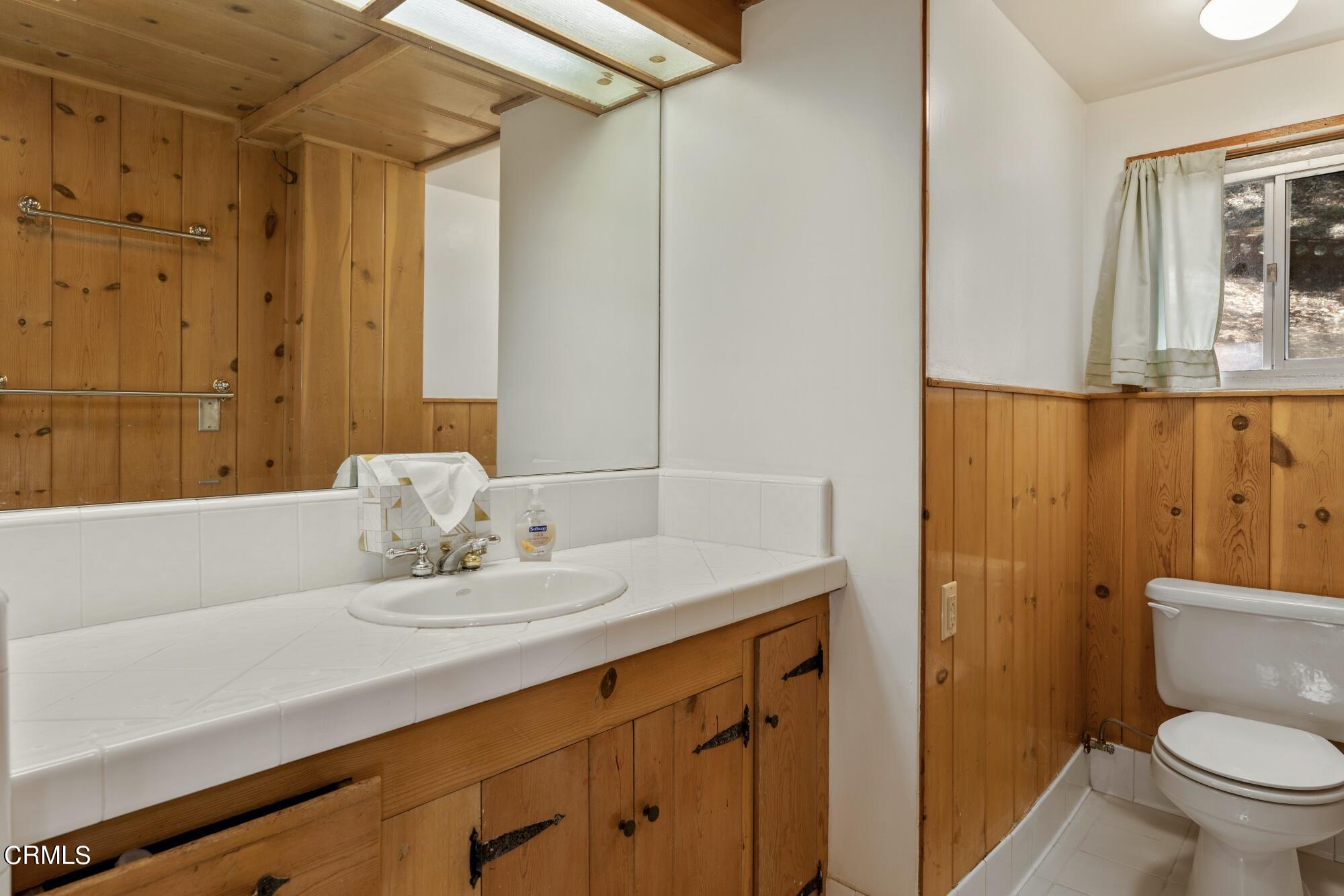 9710 Mistletoe Road Tujunga, CA 91042 - Photo 26 of 68 a bathroom with a sink a toilet and shower