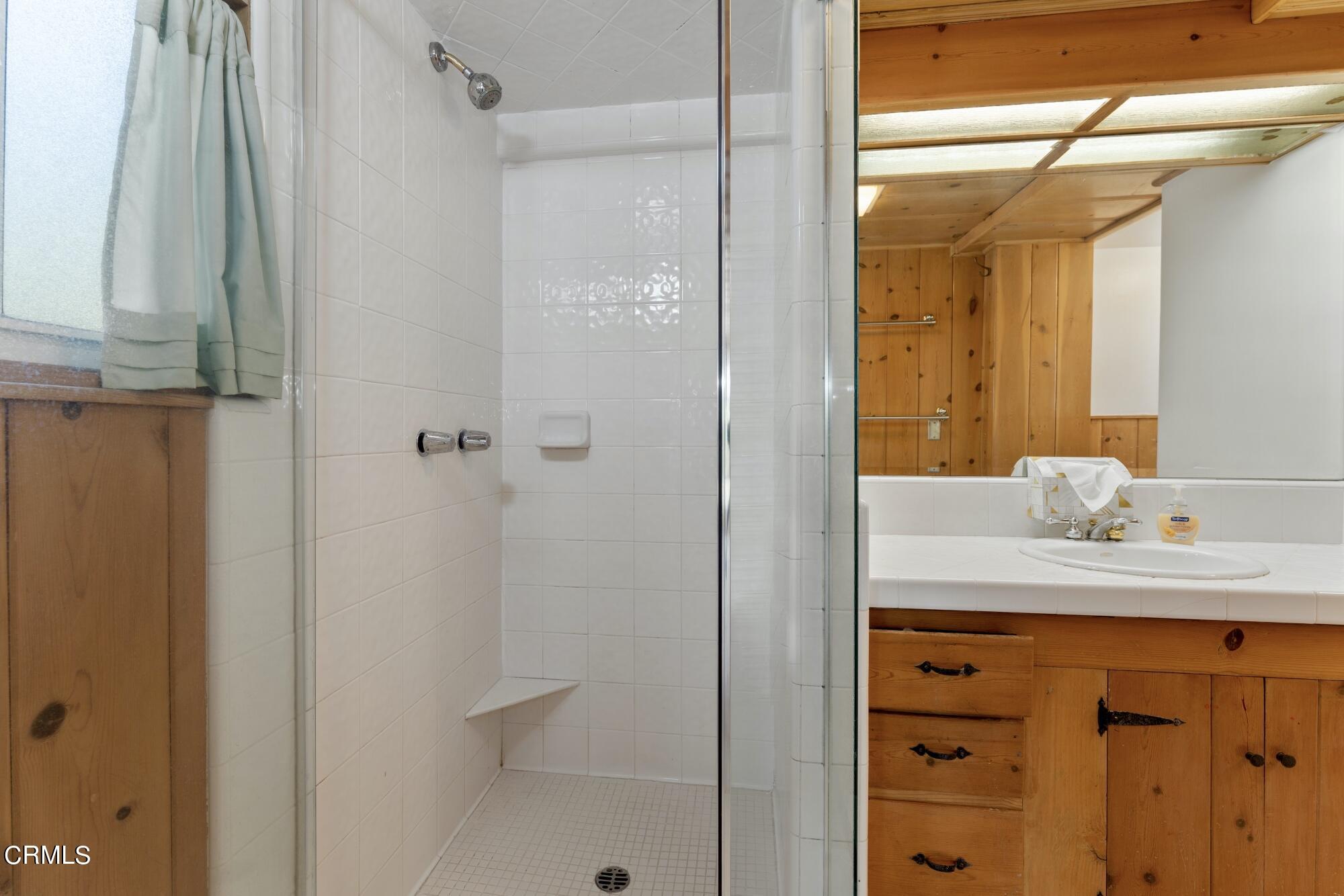 9710 Mistletoe Road Tujunga, CA 91042 - Photo 27 of 68 a bathroom with a granite countertop sink and a mirror