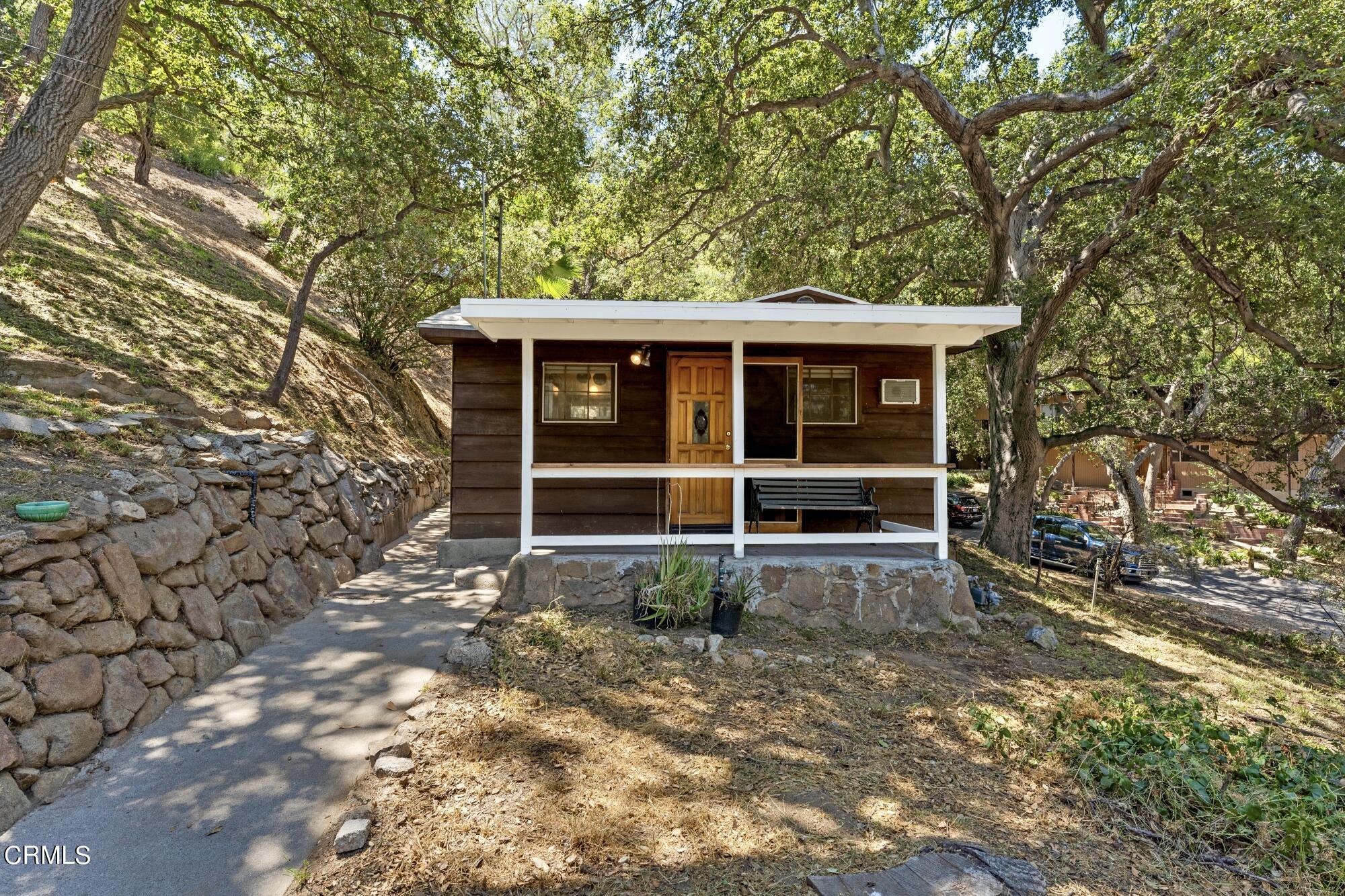 9710 Mistletoe Road Tujunga, CA 91042 - Photo 39 of 68 a view of a house with a large window and a large tree
