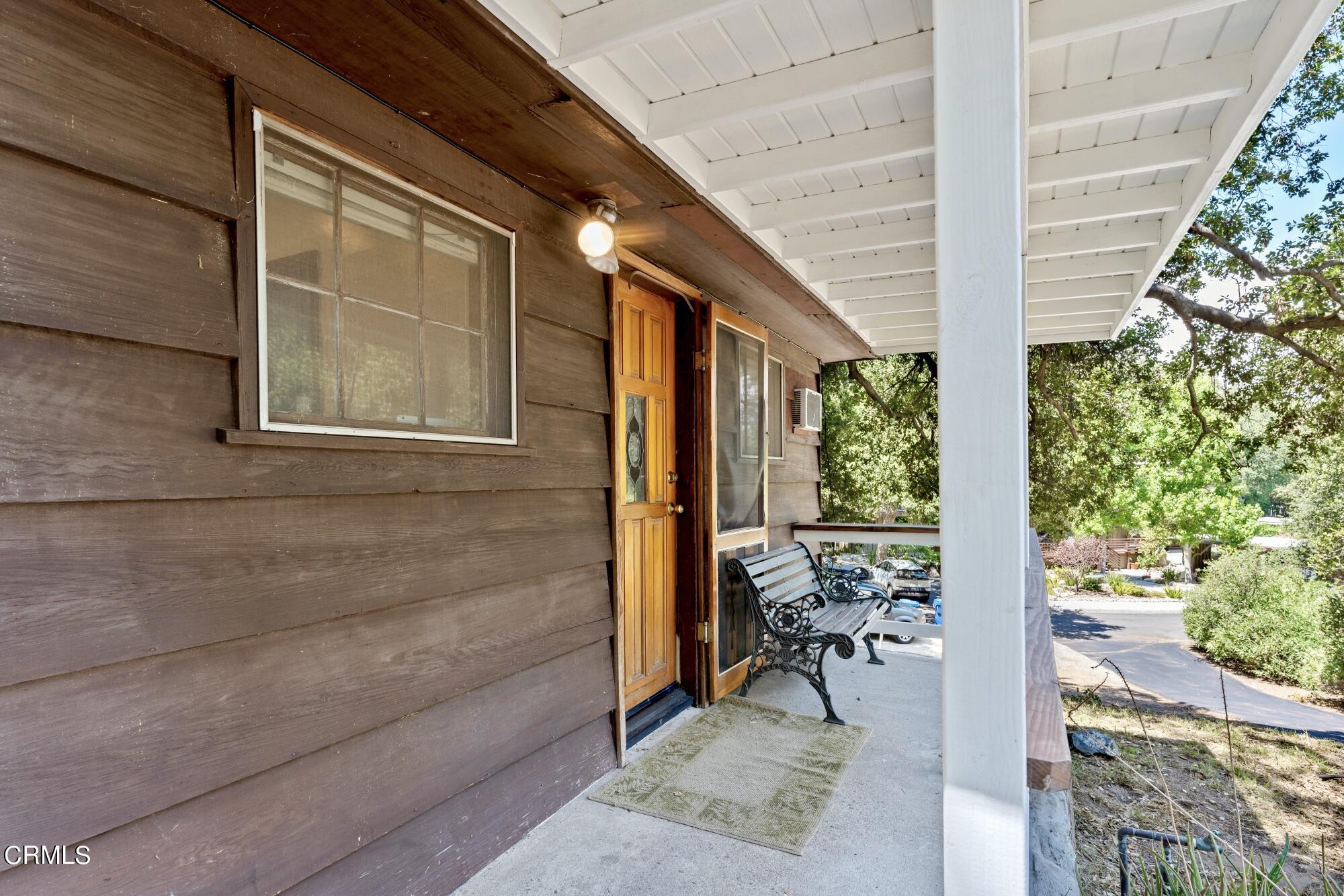 9710 Mistletoe Road Tujunga, CA 91042 - Photo 42 of 68 a view of a patio with table and chairs and potted plants
