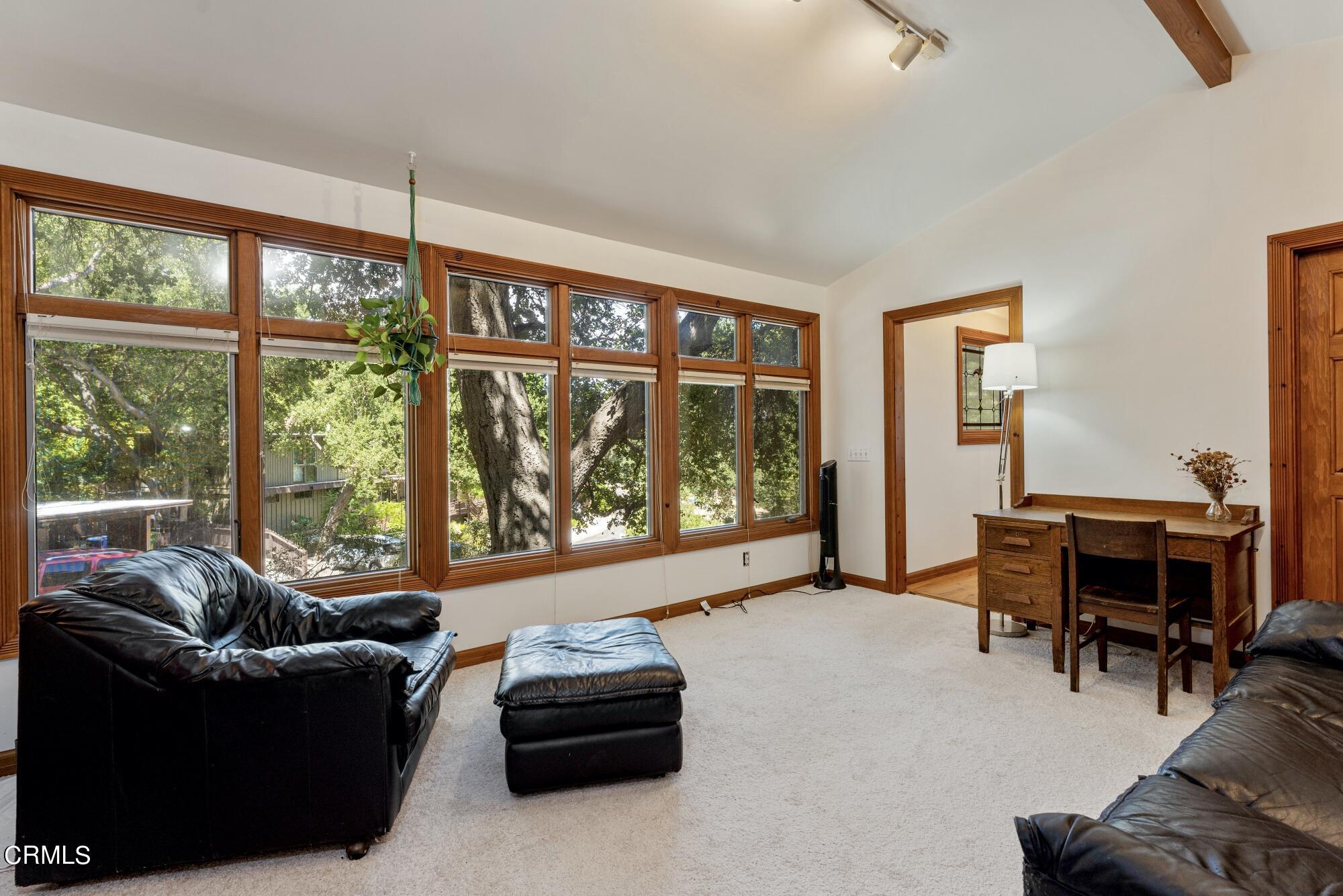 9710 Mistletoe Road Tujunga, CA 91042 - Photo 52 of 68 a living room with furniture a table and a large window