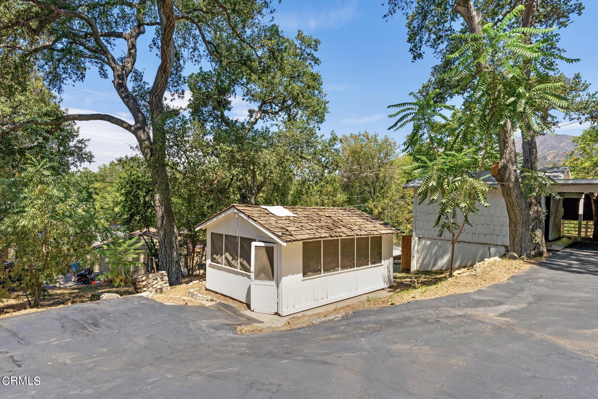 9710 Mistletoe Road Tujunga, CA 91042 - Photo 60 of 68 a white house covered with tall trees