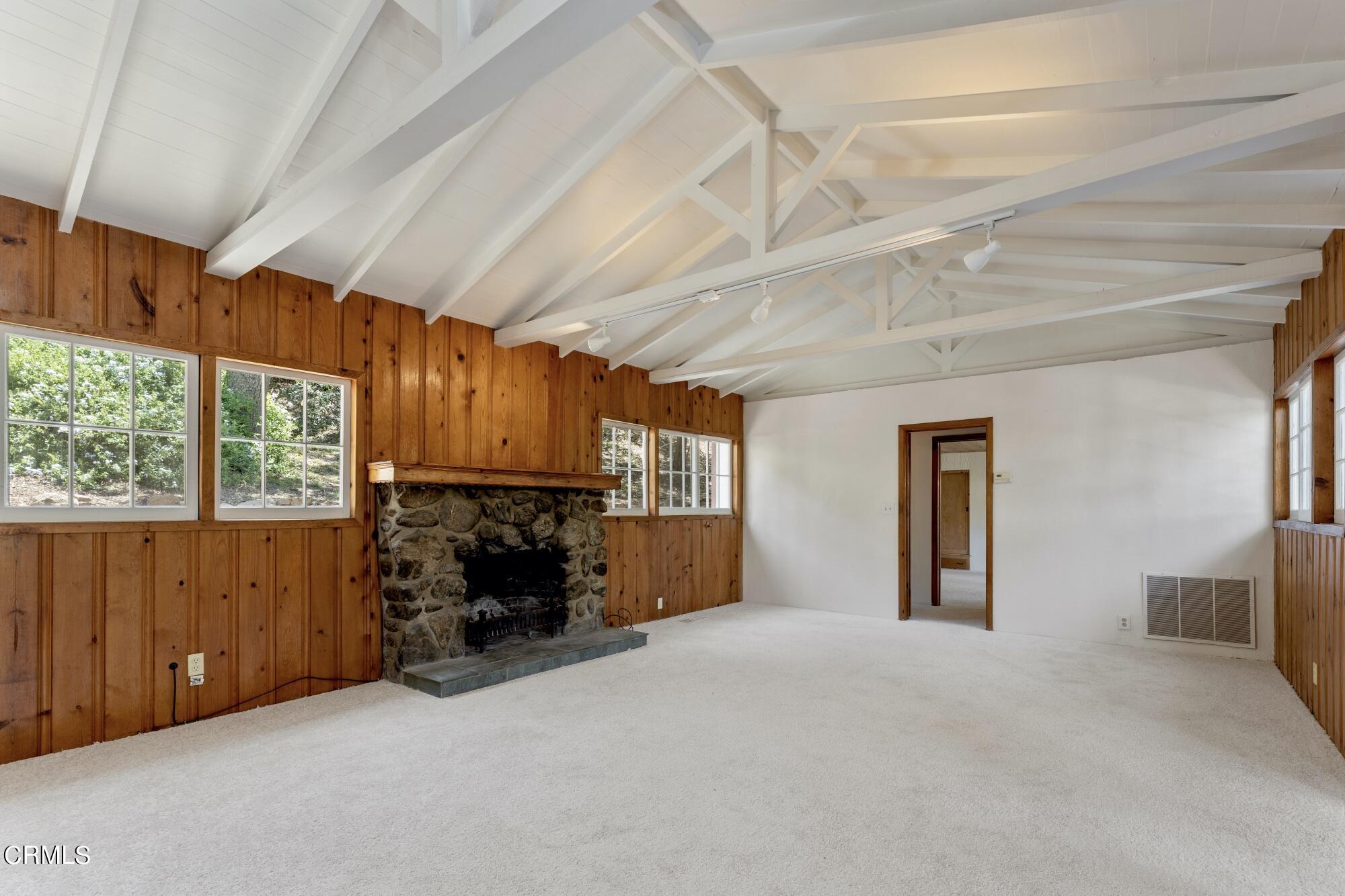 9710 Mistletoe Road Tujunga, CA 91042 - Photo 10 of 68 an empty room with windows fireplace and windows