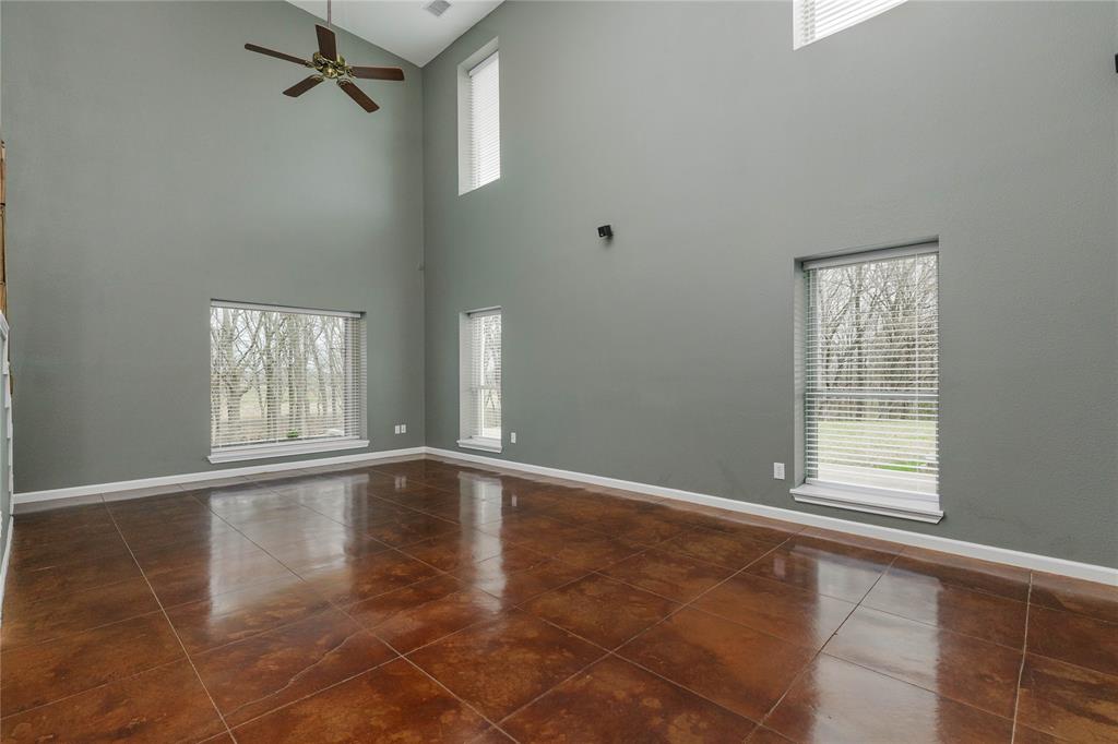 1878 North Lincoln Park Road Van Alstyne, TX 75495 - Photo 13 of 32 a view of an empty room with wooden floor and a window
