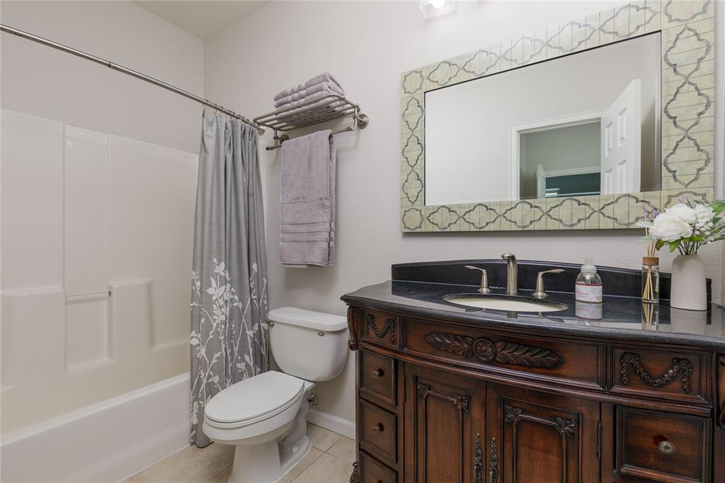 1878 North Lincoln Park Road Van Alstyne, TX 75495 - Photo 18 of 32 a bathroom with a sink toilet vanity and shower
