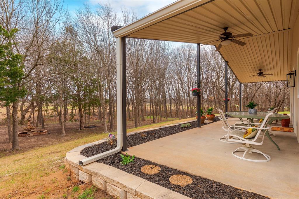 1878 North Lincoln Park Road Van Alstyne, TX 75495 - Photo 6 of 32 a view of a patio with a table and chairs