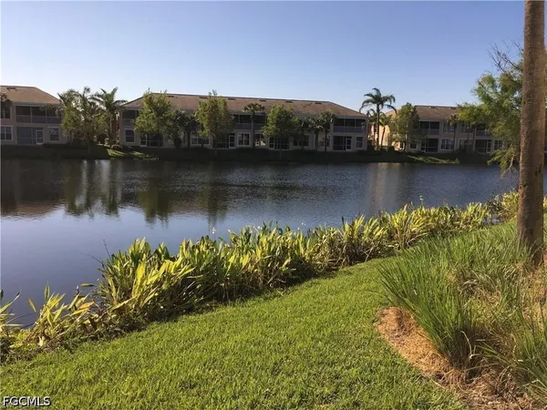 a view of a lake with houses in the back