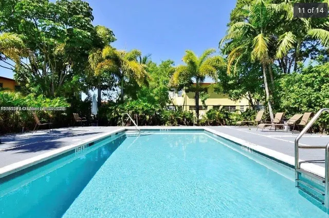 a view of a backyard patio and swimming pool