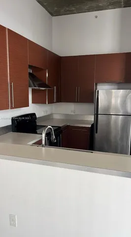 a kitchen with a refrigerator and a stove