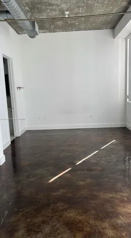 a view of room with wooden floor